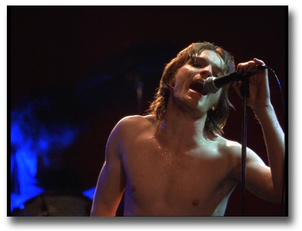 Scene from 'Velvet Goldmine' of Ewan McGregor singing at a concert