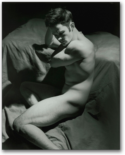 Black and white of male nude sculpted in a strong down light