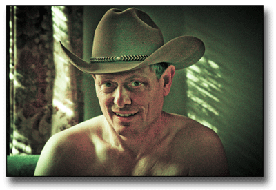 Nude of Terry with his cowboy hat in bedroom.