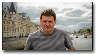 Terry Cyr standing on bridge in Paris France.